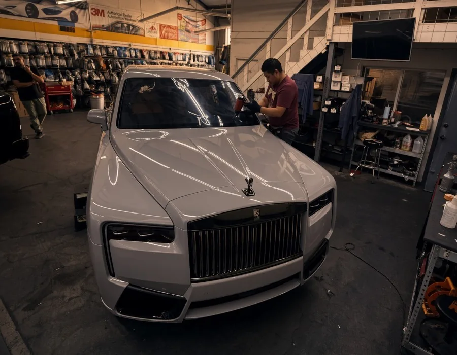 White Rolls-Royce Cullinan with window tint, in the shop